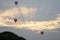 Three hot air balloons in the sky during sunrise in Bagan, Nyaung-U, Myanmar