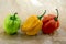 Three hot peppers habanero, various color on creased beige brown paper, mexican cuisine very hot ingredients