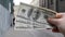 Three hundred dollar bills on blurred background of european old street town