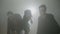 Three hungry scary zombies out in fog to hunt for day of the dead -