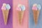 Three ice cream waffle cone shape made out of burlap and cotton balls in pink, yellow and blue