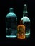 Three illuminated glass bottle in the dark