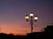 Three illuminated street lanterns during sunset, close up