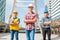 Three Industrial engineer wear safety helmet engineering standing with arms crossed on building outside.