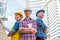 Three Industrial engineer wear safety helmet engineering standing with arms crossed on building outside.