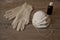 Three industrial masks, rubber gloves and bootle with pharmacy alcohol on wooden table