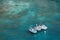 Three inflatable motor boats stand in the bay near the shore on a warm summer day