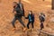 Three international friends with their backpacks on hiking trip