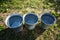 Three iron buckets of clean water on the grass