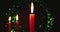 Three isolated candles are lit with a dark abstract bokeh background. Great for a Christmas background. panning shot