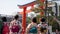 Three japanese women walking towards to Tori gate in Kyoto, Japan.