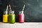 Three jars of fruit colorful drinks with straws