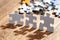 Three Jigsaw Puzzle Pieces on Table Lit by Back Light