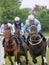 Three jockeys on race horses