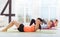 Three joyful women doing pushups in gym