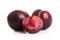 Three juicy red plums