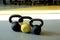 Three kettlebells  and yoga mat on the grey background