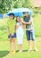 Three kids with blue umbrella