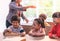 Three kids eating delivery pizza in classroom