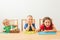 Three kids play with colorful play dough