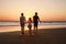 Three kids silhouettes running and jumping on beach at sunset. happy family, two school boys and one little preschool
