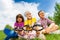 Three kids sitting close together with magnifiers