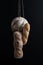 Three kinds of bread hang on a scaffolding on a black background