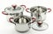 Three kitchen cooking pots with red handles and glass lids