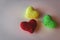 Three knitted hearts on white background. Love concept. Romance background. Three small yarn hearts. Love symbol.
