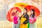 Three Korean girl wearing a hanbok wearing a yellow umbrella. Beautiful Female wearing traditional Korean hanbok with cherry