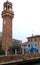 Three lanterns of the nearby church of the tower Asinelli in sun and blue skies in Bologna (Italy