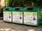 Three large green recycling bins from Camden Council. London, UK.