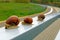 Three large snails gracefully crawl along the railing of the fence