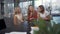 Three laughing joking girls sitting at boardroom table during a break in a business meeting.