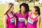 Three laughing runners supporting breast cancer marathon