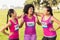 Three laughing runners supporting breast cancer marathon