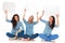 Three laughing young women holding speech bubbles and sit