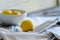 Three Lemons and Grater on White Cloth