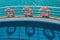 Three lifebuoy rings on the ship railing and its shadows