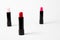 Three lipsticks on white background.