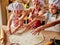 Three little chefs enjoying in the kitchen making cakes. Girls at the kitchen. Family housekeeping