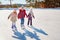 Three little girl friends learn to skate. Outdoor recreation an