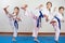 Three little girls demonstrate martial arts working together