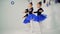 Three little girls are doing ballet exercises