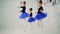 Three little girls are practicing ballet movements