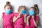 Three little girls in protective medical masks. Protection against viruses and coronavirus