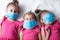 Three little girls in protective medical masks. Protection against viruses and coronavirus