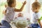 Three little Kids play near the window. Brothers and sister with the baby.Toddler kid meeting newborn sibling. Children