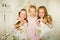 Three little princess standing on the bed