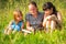 Three little sister reading book in natural